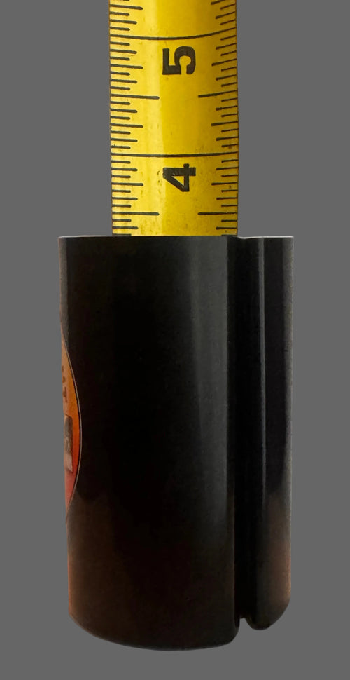 Black cylindrical object with a measuring tape showing dimensions on a light gray background